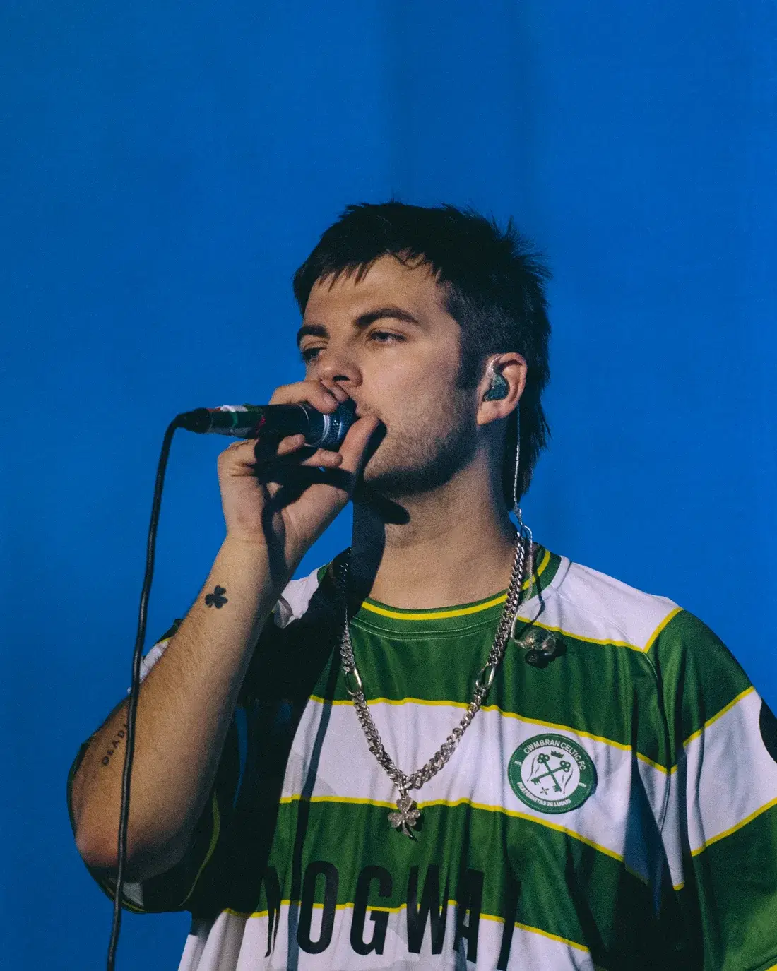Grian Chatten of Fontaines D.C. headlining Reading Festival, 28 August 2026, wearing the Cwmbran Celtic Mogwai shirt
