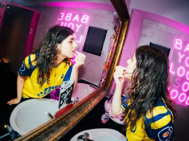 Model in the Super Furry Animals shirt at the mirror
