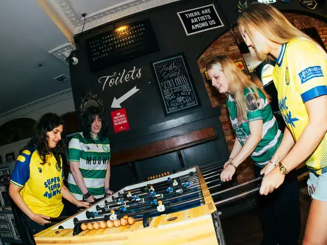 Models gathered around the foosball table at Le Pub