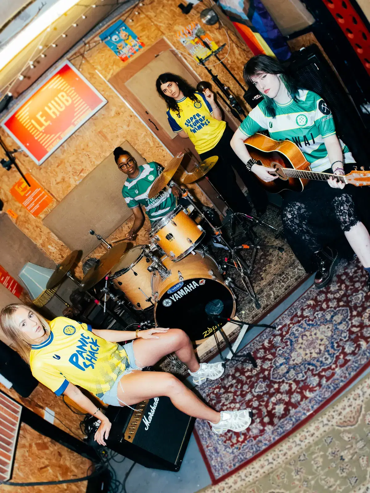 Four models set up as a band in the Le Pub rehearsal room