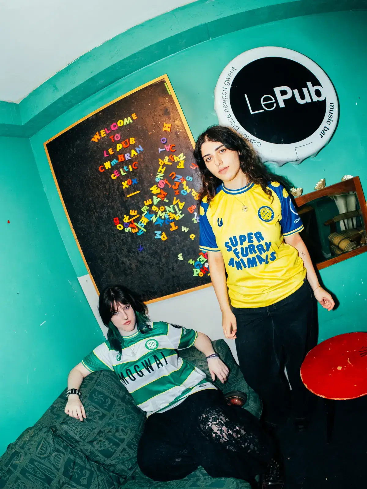 Two models by the Le Pub welcome board